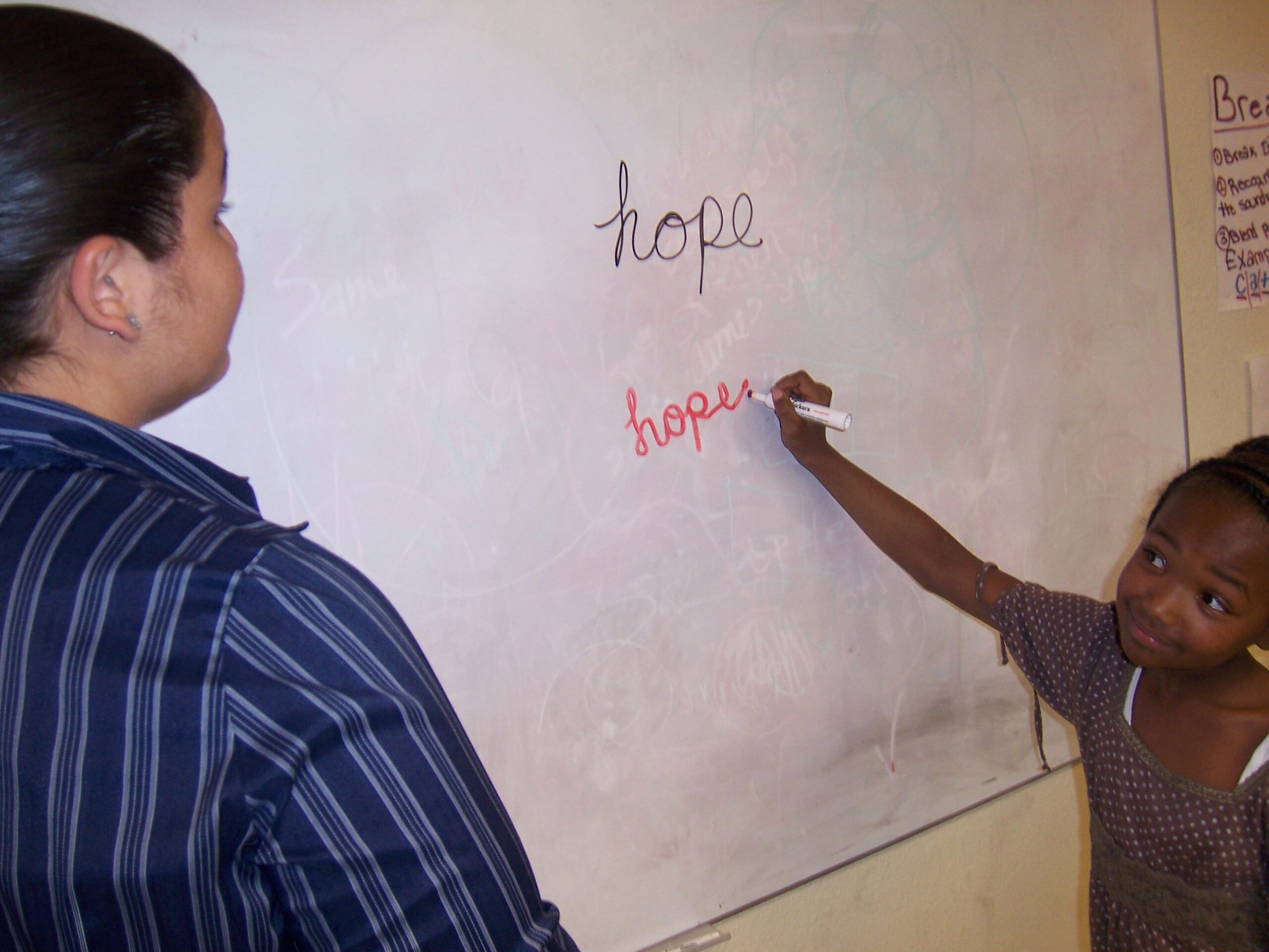 Girl-Writing-Hope-On-Blackboard - Hope Communities